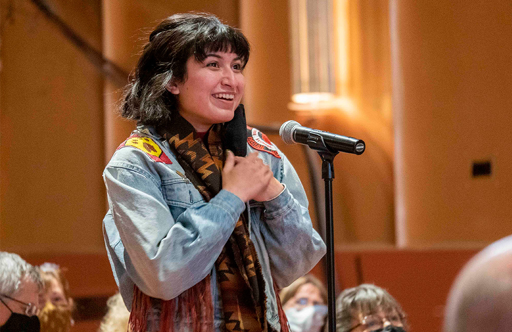 A woman asks a question during an event